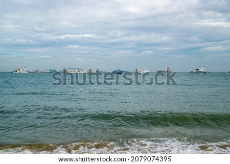Nature landscape view of beautiful waves at tropical beach and sea in sunny day. Beach sea space area with background of sail boats