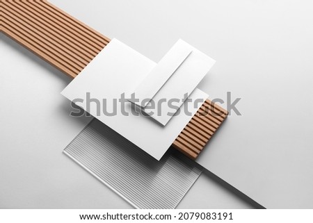 Branding stationery mockup template, with reeded glass and wooden elements, real photo, letterhead, folder, brochure, business card, envelope. Blank isolated on white background to place your design.  Royalty-Free Stock Photo #2079083191