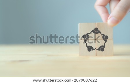 Business management concept; teamwork, collaboration, achieve a common goal. Wooden cube screening teamwork vector icon  standing on the wood table with grey background, copy space.  Royalty-Free Stock Photo #2079087622