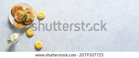 Tasty cookies and potato pancakes for Hanukkah celebration on grey background with space for text