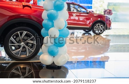 New cars at dealer showroom floors, showrooms for sale at car dealerships.