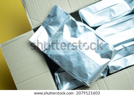 Bags plastic or foil vacuum sealed coffee in stock for coffee shop. Сoffee package.