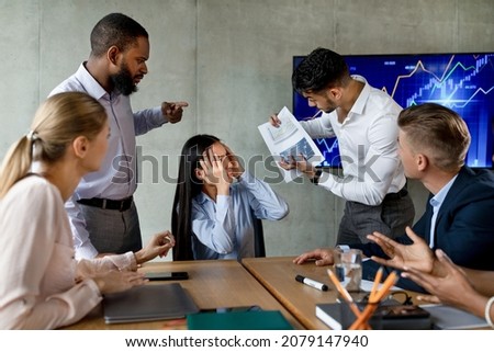 Multiethnic Business Team Having Conflicts At Work, Shouting At Unhappy Asian Female Employee, Multicultural Coworkers Having Communication Problem, Blaming Young Businesswoman For Project Failure Royalty-Free Stock Photo #2079147940