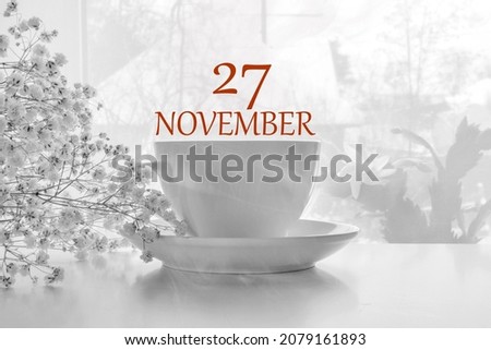calendar date on light background with porcelain white tea pair and white gypsophila with copy space. November 27 is the twenty-seventh day of the month.
