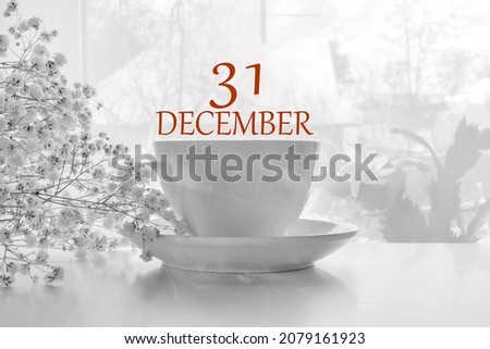 calendar date on light background with porcelain white tea pair and white gypsophila with copy space. December 31 is the thirty-first day of the month.