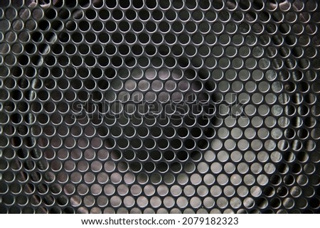 Macro shot of speaker grille. Vintage effect. Close up shot of a round speaker. Acoustic broadband speaker. Luxury car stereo system speaker. Holes in a metal lattice. Royalty-Free Stock Photo #2079182323