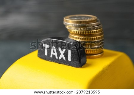 Yellow cab with coins on dark background, closeup Royalty-Free Stock Photo #2079213595
