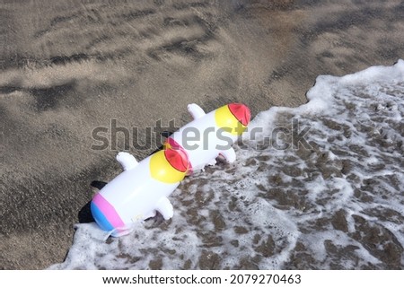 inflatable toys in the form of a penguin on the seashore, theme of items and backgrounds

