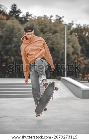 Guy with skateboard while performing trick in air