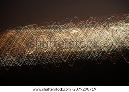 City lights in the form of lines and shot with slow shutter speeds at dusk. Can be used as background.