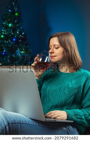 Christmas eve, woman speaking with her parents on notebook, conference call to celebrate new year with friends on quarantine time.