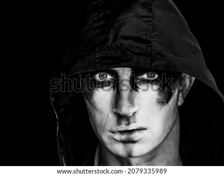 Face of man with Halloween skull makeup on the black background
