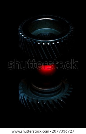 Two small transmission gears orbiting a small red sphere.