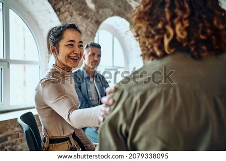 Men and women sitting in a circle during group therapy, supporting each other. Selective focus. Close up view. Royalty-Free Stock Photo #2079338095