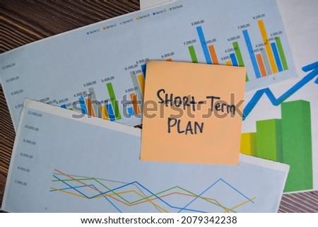 Short-Term Plan write on sticky notes isolated on Wooden Table. Stock market concept Royalty-Free Stock Photo #2079342238