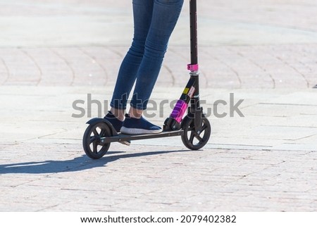Girl on a scooter in the city.