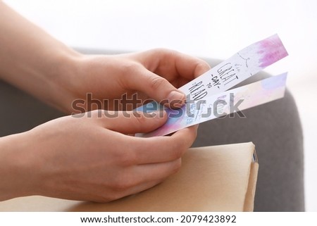 Woman with bookmarks at home, closeup