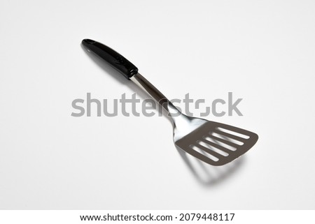 Kitchen Spatula Stainless steel isolated on white background.Slotted Spatula.High resolution photo.Top view. Royalty-Free Stock Photo #2079448117