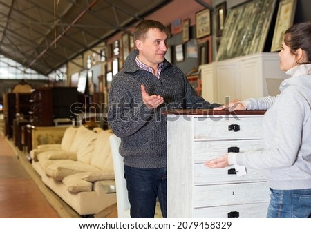 Happy adult couple visiting furniture store in search of items for home decor furnishings Royalty-Free Stock Photo #2079458329