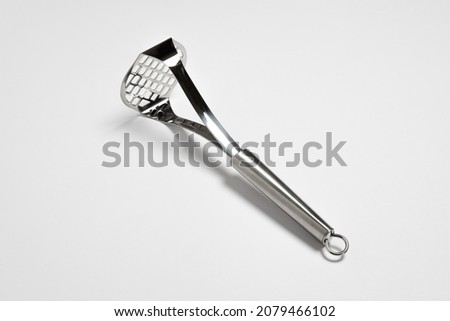 Stainless steel Potato masher with handle isolated on white background.Potato pestle. High resolution photo. Royalty-Free Stock Photo #2079466102