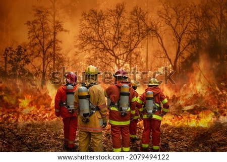 Firefighters team battle a wildfire because climate change and global warming is a driver of global wildfire trends. Royalty-Free Stock Photo #2079494122