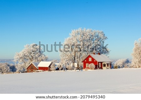 Farm in a beautiful winter landscape Royalty-Free Stock Photo #2079495340
