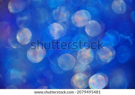 Abstract circles made of light in the night.Blue bokeh abstract background.Abstract blurred colorful circles on blue background.Element of design.