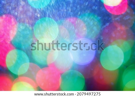 Abstract christmas background with colored lights in bokeh and sparkling splashes of light