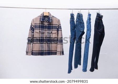 Four blue denim Jeans with checkered shirt ,jacket on hanger