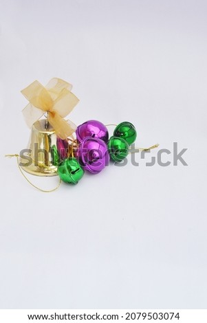 Gold Christmas bells and colorful christmas balls. Used for Christmas decorations. Negative Space.