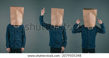 Three young men with paper bags on the head, different positions of the hands, copy space, dark background Royalty-Free Stock Photo #2079505348