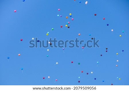 many colorful balloons in the blue sky