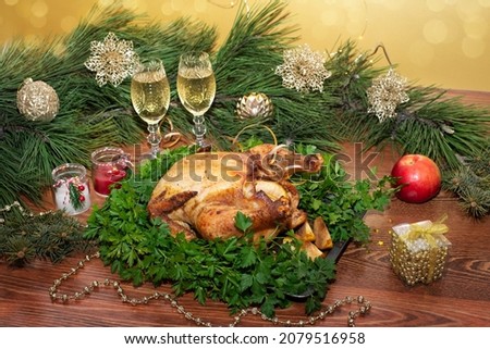 Christmas or Thanksgiving. Baked chicken stuffed with apples for Christmas dinner on the festive table.