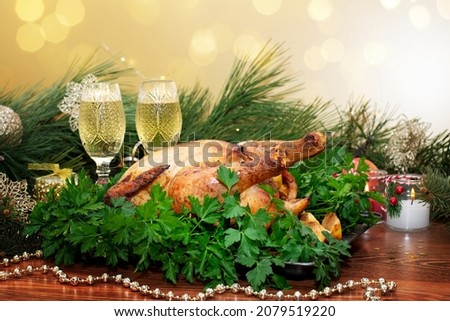 Baked chicken stuffed with apples for Christmas dinner on the festive table. Christmas or Thanksgiving.