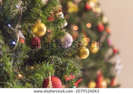 Decorated Christmas tree and colorful presents on colorful bokeh background. Merry Christmas and Happy Holidays. Christmas holiday celebration. Happy new year concept.