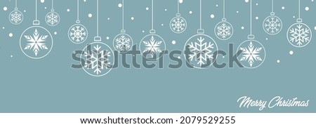 Elegant and modern card with Christmas balls with snowflakes of different sizes, round, white with congratulations and snow on a light blue background Royalty-Free Stock Photo #2079529255