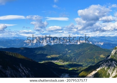 View of Dobrac mountain in Carinthia, Austria and forest covered hill in front with the town of Ratece in Slovenia bellow Royalty-Free Stock Photo #2079537577