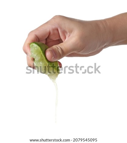 Hand squeeze green lime isolated on white background Royalty-Free Stock Photo #2079545095