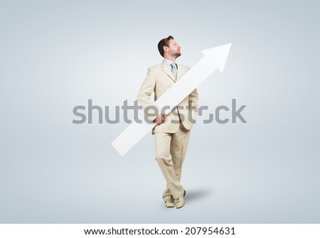 Handsome businessman with white blank arrow. Place for text