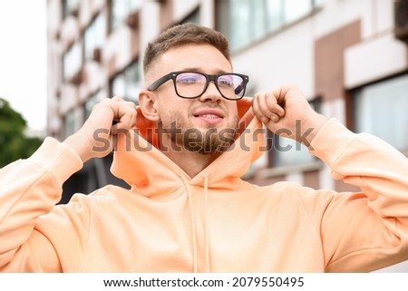 Young guy in stylish hoodie outdoors