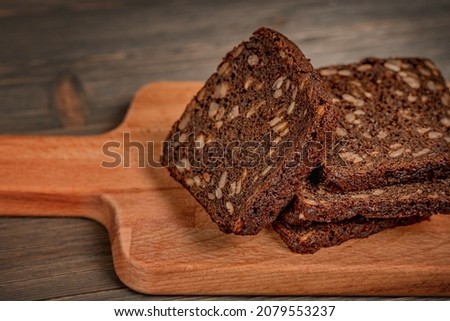 Multi-grain black bread on a wooden board