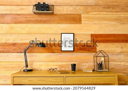Modern workplace near wooden wall