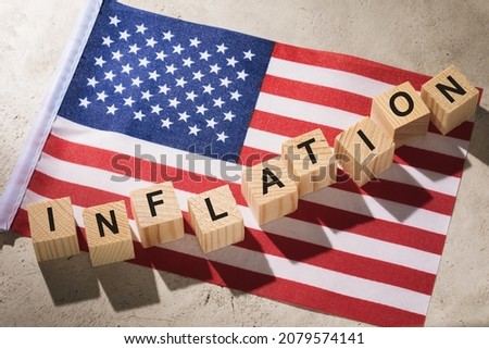 USA flag and wooden cubes with text, concept on the theme of inflation in America Royalty-Free Stock Photo #2079574141