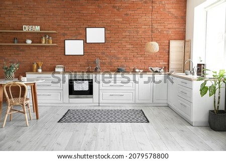 Interior of modern kitchen with blank photo frames