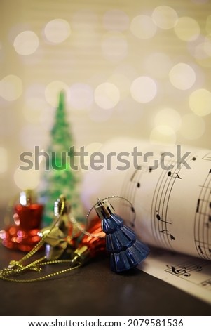 Christmas Sheet Music. Christmas decorations on music sheets, closeup

