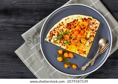 Leipajuusto, kaffeost, bread cheese, finnish squeaky cheese slices with cloudberry jam and fresh mint on a white plate on a black wooden table, flat lay Royalty-Free Stock Photo #2079587539