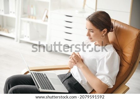 Psychologist working with patient online while sitting in office Royalty-Free Stock Photo #2079591592