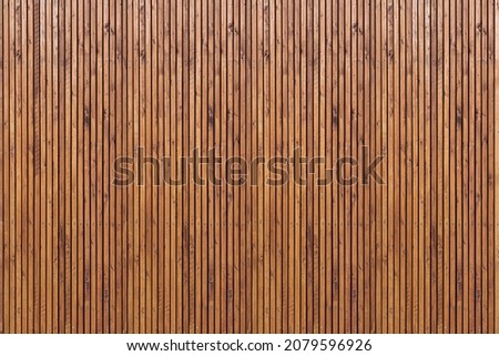 Wall of wooden slats. Wooden floor. Wooden fence. Wooden wall. Modern architectural wall. Royalty-Free Stock Photo #2079596926