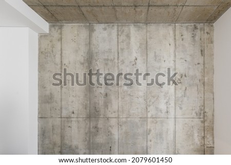Grey concrete wall. Clay wall texture with cracks and imperfections. Modern interior concept