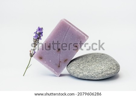 Lavender soap on the pedestal from sea stone on light background.